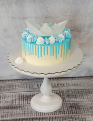 kid's cake with wafer paper ship, color drip and merengues