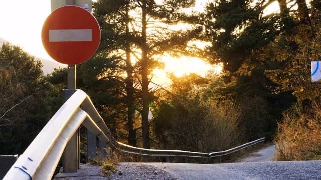 Stop sign next to an empty asphalt road in the Pyrenees mountains. 4K
