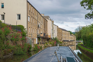 View from narrowboat traveling on a British canal in urban setting