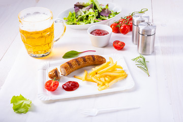 delicious bratwurst with rolls and beer