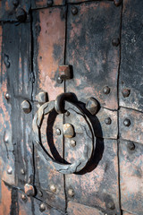 Antique door with a door ring. Iron and rivets.