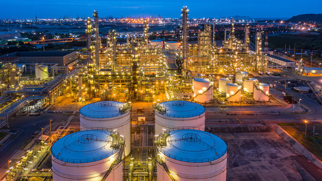 Aerial view petrochemical plant and oil refinery plant background at night,  Petrochemical oil refinery factory plant at night.