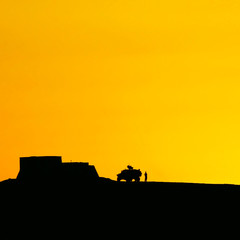 silhouette image of military vehicle at sunset