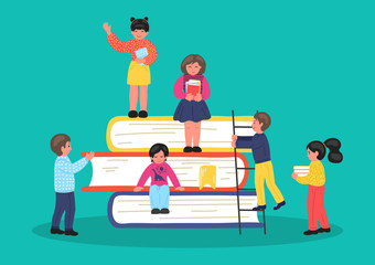 Group of tiny children on stack of books.