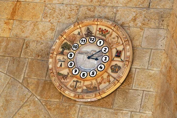 Fotobehang Old clock face shows time signs zodiac on western wall city Jerusalem © Oleksandr