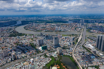 Fototapeta premium Top View of Building in a City - Aerial view Skyscrapers flying by drone of Ho Chi Mi City with development buildings, transportation, energy power 