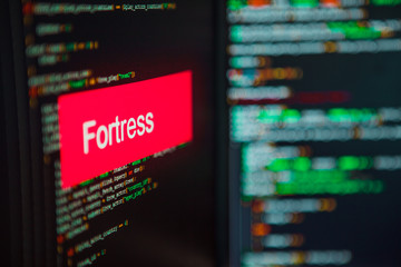 Programming language, Fortress inscription on the background of computer code.