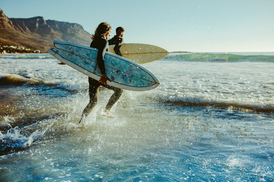 To young surfers going for water surfing