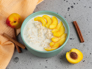 Oatmeal with milk and a peach or nectarine and cinnamon