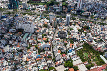 Top View of Building in a City - Aerial view Skyscrapers flying by drone of Ho Chi Mi City with development buildings, transportation, energy power 