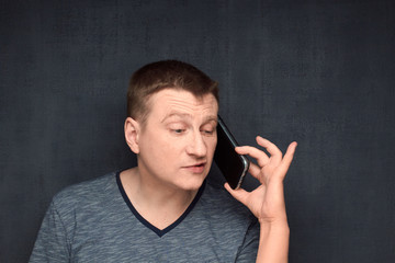 Portrait of man talking on phone with scornful expression