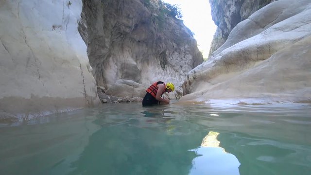 person injury on travel, emotional young male tourist in protective clothing in active journey got knee-leg injury is in acute pain being in extreme environmental conditions