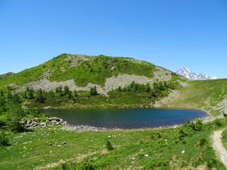 a lake in the Alps of Val Bognanco during a summer day, near the village of Domodossola, Italy - June 2019.