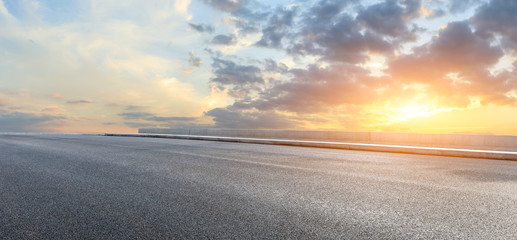 Asphalt highway and beautiful clouds landscape at sunset