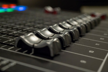 Audio Mixer with Faders pushed up on a Yamaha Mixer