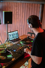 DJ playing on wooden booth at party