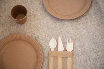 ecological disposable tableware paper cardboard empty on a wooden table