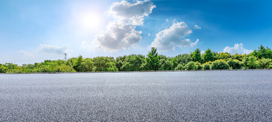Asphalt highway and green forest with beautiful clouds landscape