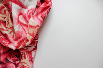 white background with a pink scarf in the left side