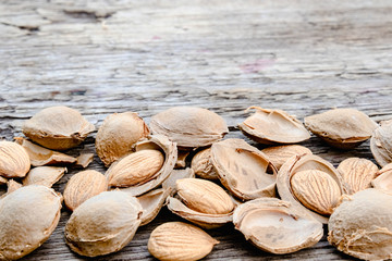 The core of apricots and stones on the background of old boards. Apricot pits for the manufacture of tablets and drugs.