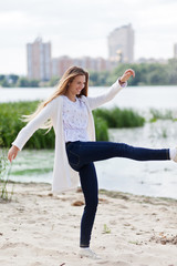 Girl splashing sand with her legs.Lifestyle concept. Close-up