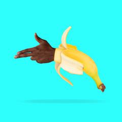Making a shot. Banana with male hand showing the sign of a gun on blue background. Negative space to insert your text. Modern design. Contemporary art. Creative conceptual and colorful collage.