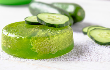 Sliced cucumber and soap on a white background. Home body care cucumber and care concept.