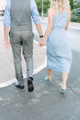 boy and girl walk holding each other's hand