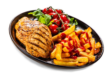 Grilled chicken fillet with french fries on white background