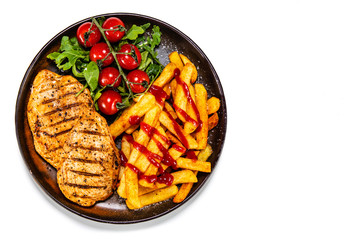 Grilled chicken fillet with french fries on white background