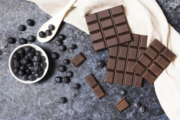 Top view arrangement with dark chocolate and blueberries