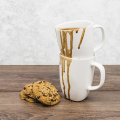 Front view dirty mugs with cookies