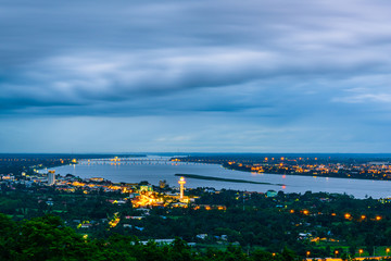 Aerial view of Mukdahan city with Ho Kaeo Mukdahan and Savannakhet province at twilight time, the region with the Mekong River in the middle