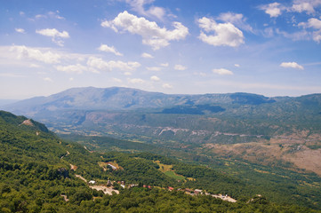 Fototapeta na wymiar Beautiful mountain landscape on sunny summer day. Montenegro, Dinaric Alps, view of Bjelopavlici plain near Ostrog monastery