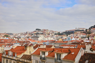 Fototapeta na wymiar Lisbon Portugal - Beautiful panoramic view of the red roofs of houses in antique historical district Alfama and the Tagus River and bridge from Sao Jorge Castle