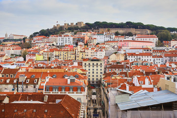 Naklejka premium Lisbon Portugal - Beautiful panoramic view of the red roofs of houses in antique historical district Alfama and the Tagus River and bridge from Sao Jorge Castle