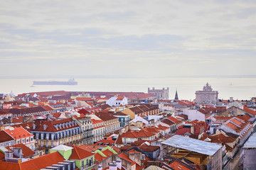 Fototapeta na wymiar Lisbon Portugal - Beautiful panoramic view of the red roofs of houses in antique historical district Alfama and bridge from Sao Jorge Castle