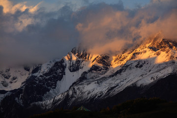 Four Girls Mountain National Park near Xiaojin, Sichuan Province China. Yaomei Peak Scenic Area, blue sky and clouds. Golden Fall Colors, Yellow Tree Leaves, Mount Siguniang, Hiking Destination