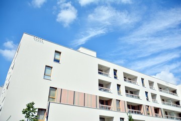 modern apartment building with blue sky and clouds