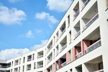 modern apartment building with blue sky and clouds