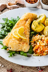 Fish dish - fried fish fillet boiled potatoes and vegetables
