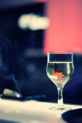A glass of champagne is on the bar
