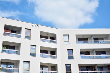 modern apartment building with blue sky and clouds