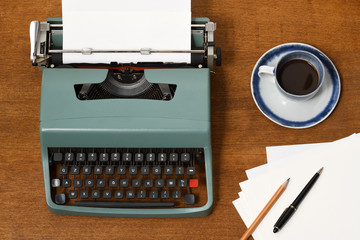 vintage typewriter with coffee cup