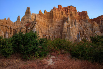 Earth Forest of Yuanmou in Yunnan Province, China - Exotic earth and sandstone formations glowing in the sunlight. Naturally formed pillars of rock and clay with unique erosion patterns. China Travel