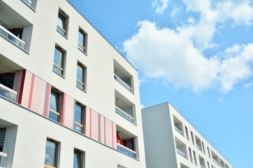 modern apartment building with blue sky and clouds