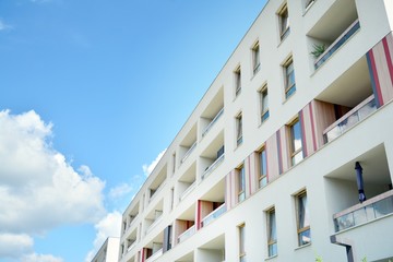 modern apartment building with blue sky and clouds