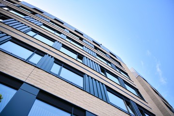 modern office building with blue sky and clouds