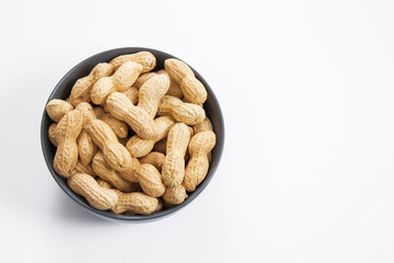 Peanut nuts in bowl, isolated white background