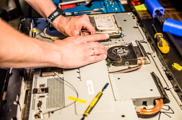 man disassembles monoblock for repair and cleaning